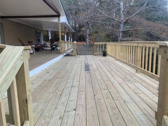 New stained wood deck off a country home
